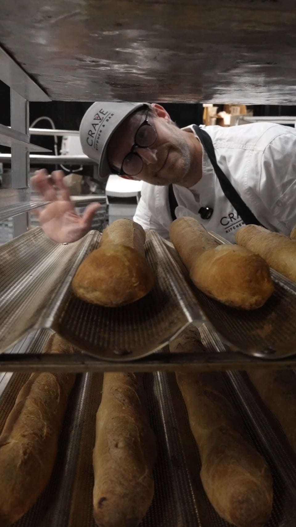 Commercial for Crave Kitchen & Bar — plated dishes and open-kitchen fire