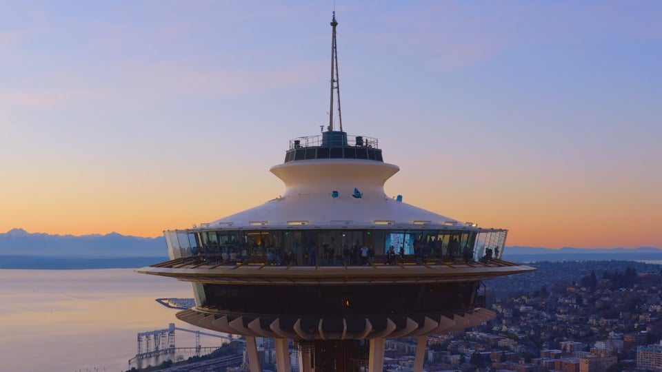 Aerial drone film of the Space Needle at golden hour above Seattle